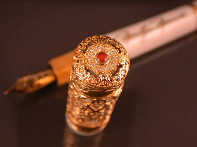 The lipstick is encapsulated under a clear dome and surrounded by hand set pave diamonds